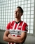 Camisa de futebol PSV 2024/25 I Home da Puma, com listras vermelhas e brancas, destacando o logo do time e o nome "Brainport Eindhoven".