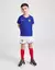 Kit infantil da seleção da França com camisa azul e calças brancas, estampado com o logo da Nike e o emblema da seleção.