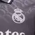 Camisa de futebol cinza do Real Madrid, modelo 24/25, com logo da Adidas e patrocínio da Emirates.