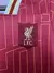 Kit infantil do Liverpool I Home 24/25 da Nike, composto por camisa vermelha e shorts.