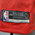 Regata vermelha NBA Nike Chicago Bulls com o nome Jordan e número 23, vista traseira.