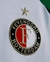 Camisa do Feyenoord 2024/25 III, nas cores verde e branco, com logotipo e patrocinadores visíveis.