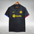 Camisa polo preta do Barcelona 23/24, com detalhes em azul e vermelho, e logotipo da Nike e Spotify.