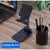 Suporte universal para celular e tablet em preto, com design ajustável e base estável, mostrado em diferentes ângulos e posições.