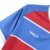 Camisa de futebol com design em azul e vermelho, destacando o logo da marca Volt.