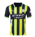 Camisa masculina do Manchester City 24/25 II da PUMA, com listras em amarelo e azul escuro.