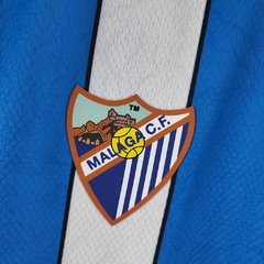 Camisa Málaga I 22/23 - Torcedor Hummel Masculina - Azul com detalhes em branco e preto - loja online