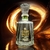 Botella de Mezcal Cuishe Joven de Gran Valle, con fondo iluminado en tonos dorados. 