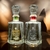 Botellas de mezcal Gran Valle, una de Maguey Cuishe y otra de Maguey Tobalá, exhibidas sobre una superficie reflejante.