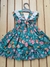 "Vestido Florido com Fundo verde 3D, Maxi Laço nas Costas e Ombro Babado: Elegância e Estilo Floral em Cada Detalhe!" - comprar online