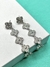 Brinco Van cleef cravejado