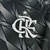 Logotipo do Flamengo em destaque na camisa do time, com fundo texturizado em tons escuros.