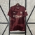 Camisa do Manchester City 24/25, modelo manto 3, na cor vinho com detalhes em preto e logo da Puma.