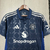 Camisa do Manchester United 2024/2025, modelo manto 2, na cor azul, com detalhes em branco e logo da equipe.