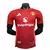 Camisa versão jogador do Manchester United 24/25 manto 1, na cor vermelha, com detalhes em branco e laranja, exibindo o logo da Adidas e o patrocinador Snapdragon.