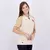 Modelo usando a camisa feminina do Vasco 24/25 manto 3, com detalhes em dourado e o escudo do clube.