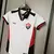 Camisa feminina do Vitória 24/25, modelo Manto 2, em cores branca, vermelha e preta, com logotipo do clube e etiqueta da marca Volt.