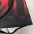 Detalhe da camisa feminina do Vitória 24/25, mostrando as listras vermelhas e pretas, com a inscrição "1899" em vermelho.