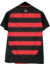 Camisa feminina do Flamengo 25/26, com listras vermelhas e pretas, destacando o emblema do clube e o logo da Adidas, com urubu.