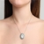 Colar Nossa Senhora em ródio branco cravejado em verde esmeralda - comprar online