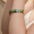Bracelete Feminino Rígido Com Zircônias Verdes Em Aço Inox Prata - comprar online