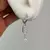 ARGOLLAS ACERO BLANCO CON DIJE STRASS - FLECHA
