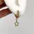 ARGOLLAS CUBANAS ACERO DORADO CON DIJE STRASS - ESTRELLA