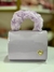 Bolsa Infantil Cor Lilás Alça de Mão Peludinha e Alça de Corpo Corrente na internet