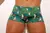 Men's boxer swim briefs featuring a vibrant cockatoo and tropical foliage print.