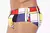 Side view of Yves Low Rise Cut Men's swim trunks featuring a colorful abstract geometric pattern.