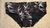 Bamboo low rise cut swimwear featuring a black background with a leaf pattern.