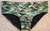 Low rise cut swimwear in a camouflage pattern, featuring a green and black design.