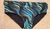 Low rise cut swimwear in vibrant blue, yellow, and black wave patterns.