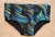 Magic Classic Swim Trunks for men featuring a vibrant blue and yellow wave pattern on a black background.