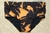 Sunset Traditional Trunks featuring a black and orange palm leaf design on swimwear