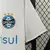Camisa branca do Grêmio, modelo 2 Away 24/25, com logo do clube e patrocínio em destaque.