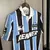 Camisa de futebol Grêmio Titular 95/96 na versão retro, predominantemente azul e preta, com detalhes em branco.