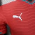 Camisa oficial da seleção de Portugal masculina para a Copa do Mundo 2026, modelo Jogador Puma, na cor vermelha com detalhes em azul e branco