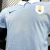 Camisa oficial da Seleção Uruguai masculina para a Copa 2026, azul celeste com gola branca, logo Nike e escudo da Federação Uruguaia de Futebol