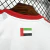 Camisa branca oficial da seleção dos Emirados Árabes Unidos 26/27 masculina Adidas com detalhes vermelhos e escudo UAE FA