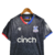 Camisa Crystal Palace III 23/24 - Torcedor Macron Masculina - Preta com detalhes em vermelho e azul - CAMISAS DE FUTEBOL | Futzzy Artigos Esportivos