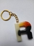 Chaveiro de resina em forma da letra R com detalhes em laranja e preto.