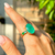 ANEL OVAL DE FUSION ESMERALDA ARO CRAVEJADO COM CRISTAL RUBI, CRISTAL TANZANITA E PARAIBA