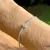 PULSEIRA GOTINHA CRAVEJADO DE CRISTAL ÁGUA MARINHA E ZIRCÔNIAS BRANCAS 19CM