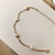 Pulseira em ouro 18K com quatro bolinhas e pérolas.
