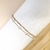 Pulseira dupla com elos e pérolas em formato de coração, confeccionada em ouro 18K.