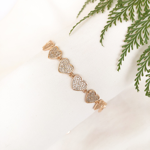 Pulseira de ouro 18k com corações cravejados de zircônias, luxuosa e elegante.