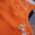 Atlética naranja con bordado de osito - comprar en línea