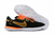 Chuteira Nike Streetgato Futsal em preto e laranja e a sola branca.