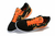 Chuteira Nike Streetgato Futsal em preto e laranja e a sola branca.